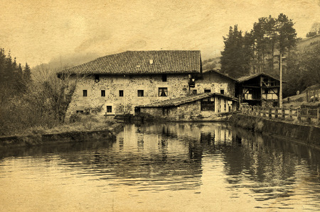 Old watermill in Ibarra, Orozko, with vintage postcard filter effectの写真素材