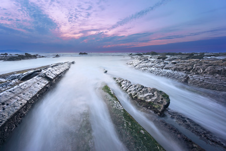 rocks in Barrika beach at the sunset