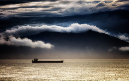 cargo ship with stormy weather on the seaの写真素材