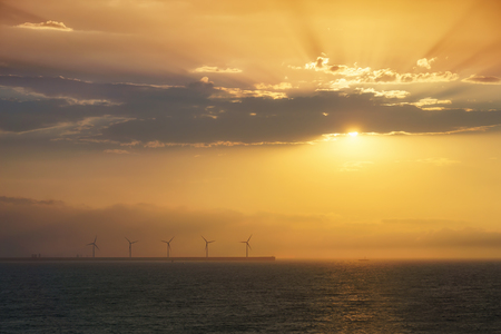 sea wind turbines at sunsetの写真素材