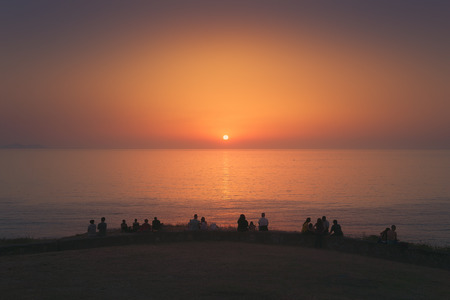 people watching the sunset on the sea in Barrika