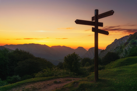 signpost in the mountain at the sunsetの写真素材