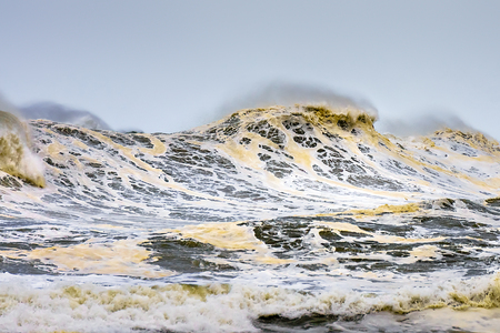 rough sea with waves breaking and foamの写真素材