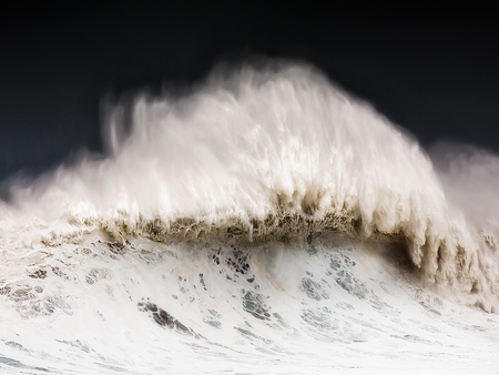 big wave breaking on a windy dayの写真素材