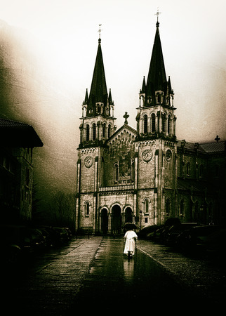 Priest going to Covadonga church in Asturias with vintage effectの写真素材