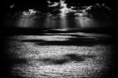 glittering water reflections on the sea at sunsetの写真素材