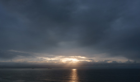 dark cloudscape sunset over the seaの写真素材