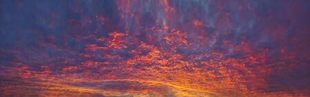 panorama of cloudscape at sunset with red clouds on sky