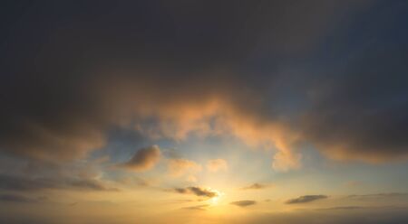 beautiful coudscape at sunset with sun and red clouds
