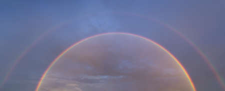 double rainbow on sky at sunsetの写真素材