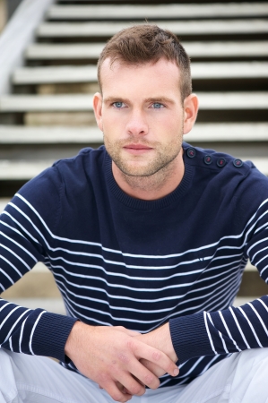 Portrait of a Handsome Man Sitting on Stairsの写真素材