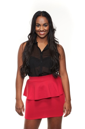 Smiling mixed race girl in black and red clothes isolated against white backgroundの写真素材