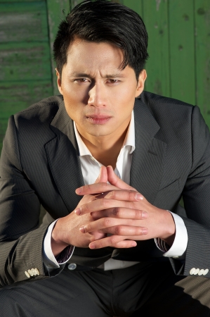 Thinking businessman alone with his thoughts. He is looking at the cameraの写真素材