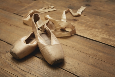 Two ballet shoes on wooden floorの写真素材
