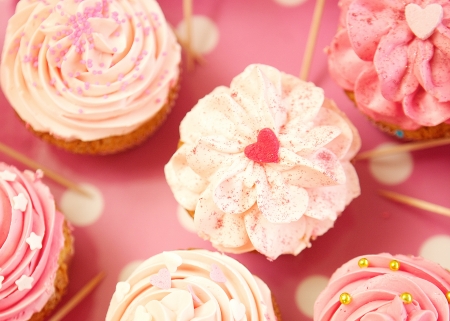 Cupcakes decorated with sprinkles and frosting - close upの写真素材