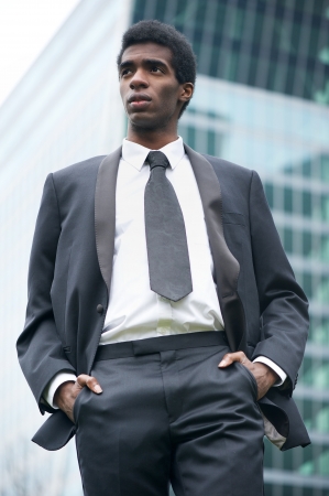 Portrait of a handsome young african american businessman standing outdoorsの写真素材