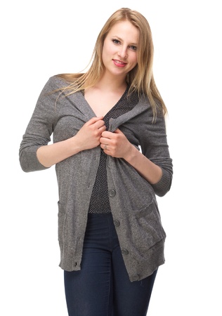 Portrait of a beautiful young woman holding cardigan isolated on whiteの写真素材