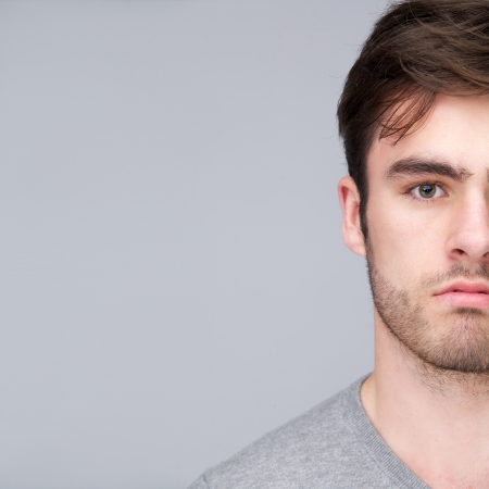 Close up half face portrait of a handsome young manの写真素材