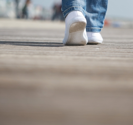 close up portrait of a female walking in comfortable white shoesの写真素材