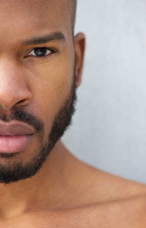 Half face portrait of a handsome young african american man shirtlessの写真素材