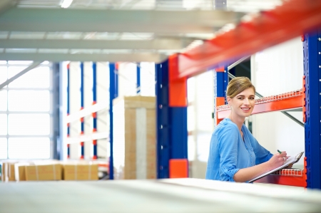 Portrait of a businesswoman  controlling inventory in a warehouseの写真素材