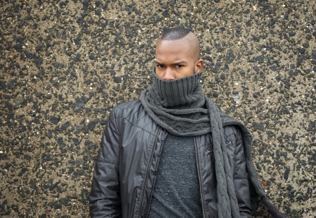 Portrait of a trendy african american fashion model with scarf covering faceの写真素材