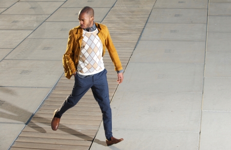 Portrait of a male fashion model walking outdoorsの写真素材