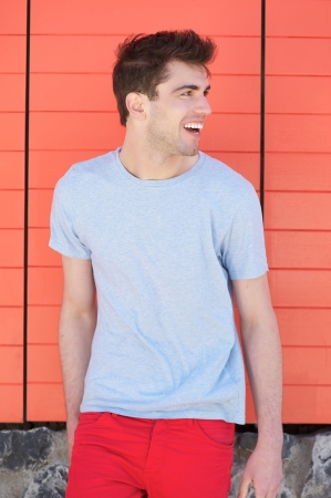 Portrait of a handsome young man smiling and looking awayの写真素材