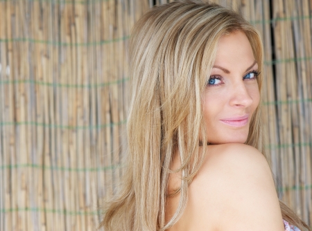 Close up portrait of a beautiful young woman looking over shoulderの写真素材