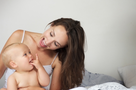 Portrait of a mother and baby laughing togetherの写真素材