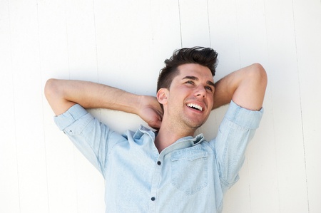 Portrait of a happy young man laughing outdoors の写真素材