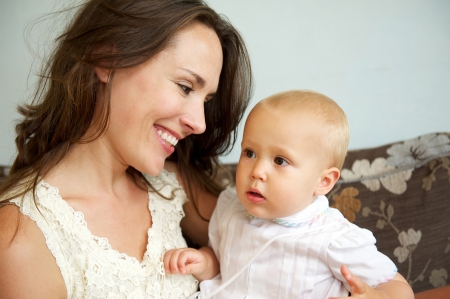 Closeup portrait of a happy mother smiling at cute baby
