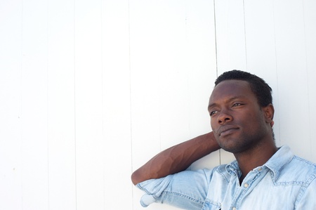 Closeup portrait of a handsome black man with relaxing against white background - copy spaceの写真素材