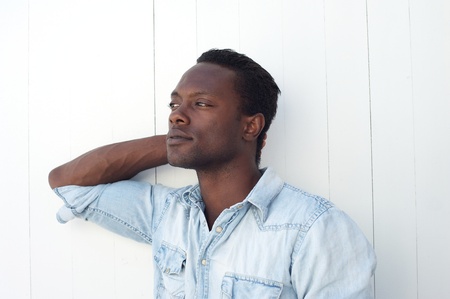 Closeup portrait of a handsome young black man with hand in hair の写真素材