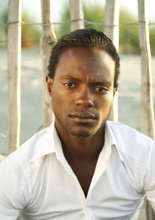 Closeup portrait of a handsome black man in white shirt の写真素材