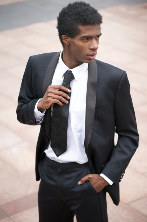 Portrait of a businessman standing outdoors in black suitの写真素材