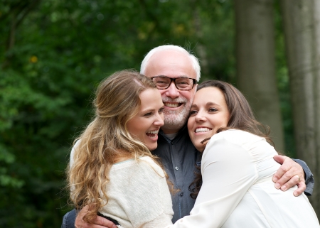 Fun portrait of a happy family with father and two daughtersの写真素材