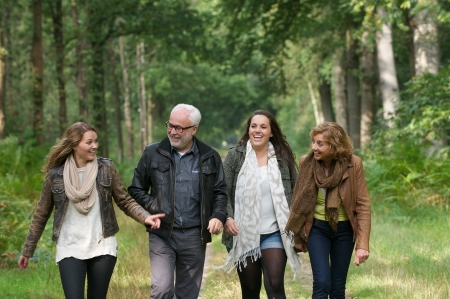 Portrait of a happy family walking in the forest together