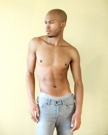Portrait of a black male fashion model posing shirtlessの写真素材