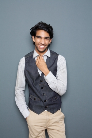 Portrait of a laughing man standing against fray backgroundの写真素材