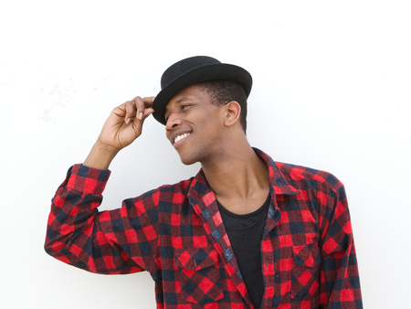 Close up portrait of a happy young man smiling with hat on white background