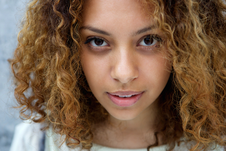 Close up portrait of a beautiful young woman with serious expression の写真素材