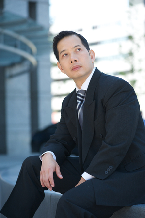 Portrait of an asian businessman posing outdoors の写真素材