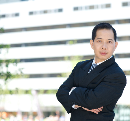 Close up portrait of a serious businessman with arms crossedの写真素材