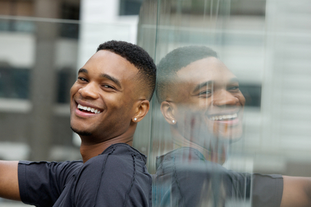 Close up portrait of a handsome young black man smilingの写真素材