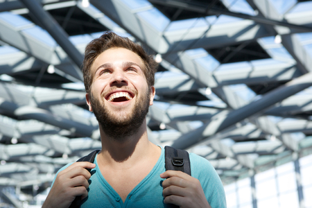 Close up portrait of a smiling man walking in airportの写真素材