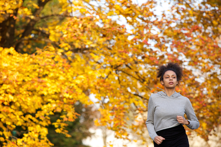 Portrait of a young woman jogging outdoors in the parkの写真素材