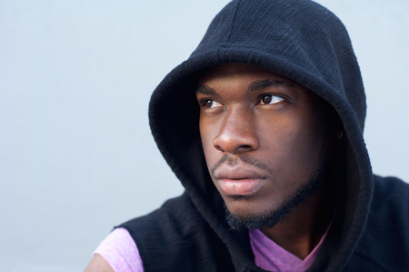 Close up portrait of a trendy young african american man with hooded sweatshirtの写真素材