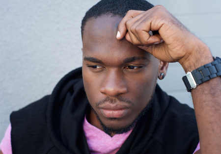 Close up portrait of a handsome black man thinkingの写真素材