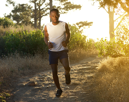 Full length portrait of an active young man running outdoorsの写真素材